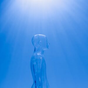 A transparent human figure under a bright blue light creating a futuristic ambiance.